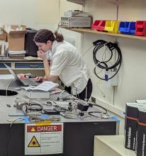 Shoshana Apple looking at laptop in a lab